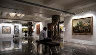 A staff member looks at his phone as artworks once part of billionaire jeweller Nirav Modi's collection are seen on display ahead of their auction at a gallery in Mumbai, India, March 25, 2019. REUTERS/Danish Siddiqui