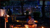 Archive Photo: A woman prays beside the grave of her relative at a cemetery during the observance of All Souls Day in Mumbai, India November 2, 2016. Reuters/Danish Siddiqui