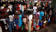 People queue for food in a camp for those displaced in the aftermath of Cyclone Idai in Beira, Mozambique, March 26, 2019. Picture taken March 26, 2019. REUTERS/Mike Hutchings