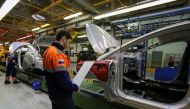 FILE PHOTO: Employees work on an assembly line at a Ford Sollers, U.S. carmaker Ford's joint venture with Russian partners, factory in Vsevolozhsk, Leningrad region, Russia July 7, 2015. Picture taken July 7, 2015. REUTERS/Igor Russak