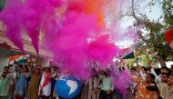 Teachers and students release coloured smoke as they celebrate after India shot down one of its satellites in space with an anti-satellite missile in a test, inside their school premises in Ahmedabad, India, March 27, 2019. Reuters/Amit Dave