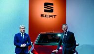 CEO of German car maker Volkswagen (VW) Herbert Diess (R) and Spanish automobile manufacturer Seat's president Luca de Meo pose in front of a SEAT car 