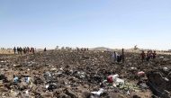 FILE PHOTO: Rescue teams collect bodies in bags amid debris at the crash site of Ethiopia Airlines near Bishoftu, a town some 60 kilometres southeast of Addis Ababa, Ethiopia. AFP / Michael TEWELDE
