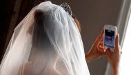 A Chinese bride takes a self portrait before her symbolic wedding in Fuessen May 31, 2012.  Reuters/Michael Dalder