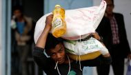 A man carries food aid he received from a local charity during the holy month of Ramadan in Sanaa, Yemen May 31, 2017. Reuters/Khaled Abdullah