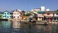 A dredger works alongside a new low-cost housing development on the Lat Phrao canal, Bangkok, part of flood-prevention work backed by the 100 Resilient Cities network, December 20, 2017, Thomson Reuters Foundation/Michael Taylor