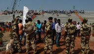 Forces stand guard next to people getting ready to watch the Indian Space Research Organisation's (ISRO) Polar Satellite Launch Vehicle (PSLV-C45) launching India's Electromagnetic Spectrum Measurement satellite 'EMISAT' -- along with 28 satellites from o