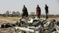 Ethiopian police officers walk past the debris of the Ethiopian Airlines Flight ET 302 plane crash, near the town of Bishoftu, near Addis Ababa, Ethiopia March 12, 2019. Reuters/Baz Ratner