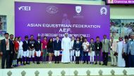 The President of Qatar and Asian Equestrian Federations, Hamad bin Abdul Rahman Al Attiyah, QEF’s Secretary-General, Bader Al Darwish, participating riders, coaches and AEF officials pose for a photograph during the AEF U-21 Dressage Championship Finals a