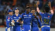 Mumbai Indians cricketer Alzarri Joseph (C) celebrates with his teammates after taking six wickets during the 2019 Indian Premier League (IPL) Twenty20 cricket match between Sunrisers Hyderabad and Mumbai Indians at The Rajiv Gandhi International Cricket 