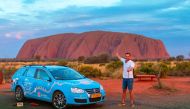 In this handout photo taken on December 31, 2018 and released on April 7, 2019 from Dutch driver Wiebe Wakker (C-R) shows him at Uluru in the Northern Territory with his retrofitted station wagon nicknamed 
