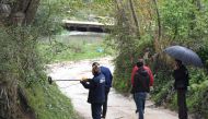 Forensic experts search for evidence near the village of Rinas, near Tirana, on April 10, 2019, at the place where police clashed with armed robbers who stole millions of euros from an Austria Airlines aeroplane in a deadly heist. AFP / Gent Shkullaku 