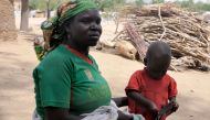Bourtaye Bigue, 36-years-old, poses with one of her children on March 22, 2019 in the Zamai displaced camp in the Cameroon extreme north region. AFP/Reinnier Kaze 
