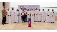 The officials of Qatar Football Association pose for a picture with the Emir Trophy during the Trophy Tour at Msheireb Properties yesterday.
