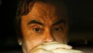 FILE PHOTO : Former Nissan Motor Chairman Carlos Ghosn sits inside a car as he leaves his lawyer's office after being released on bail from Tokyo Detention House, in Tokyo, Japan, March 6, 2019. REUTERS/Issei Kato