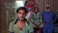 Mohammad Rafiq, 18, poses with his parents inside their house in Ahmedabad, India, April 17, 2019. Picture taken April 17, 2019. Reuters/Amit Dave