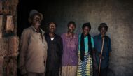 Elderly men and women, employed by the JTN tea plantation, pose for a photograph in the courtyard of the tea processing plant, near Mweso, in the Masisi Territory, North Kivu province, eastern DR Congo, on April 11, 2019. AFP / Alexis Huguet 