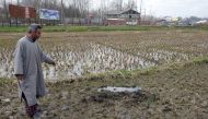 Shafqat Ahmad Bhat, a civilian, points to where he says he was forced to bury an unexploded rocket used by the Indian army in a gun battle with suspected militants in Pinglan village in south Kashmir's Pulwama district March 21, 2019.  Reuters 