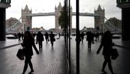 Workers walk through the More London business district with Tower Bridge seen behind in London, November 11, 2015. Reuters/Toby Melville