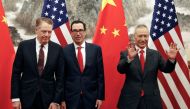 Chinese Vice Premier Liu He, right, gestures as U.S. Treasury Secretary Steven Mnuchin, center, chats with his Trade Representative Robert Lighthizer, left, before they proceed to their meeting at the Diaoyutai State Guesthouse in Beijing, Wednesday, May 