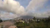 This handout picture taken and released by Indonesia's Badan Nasional Penanggulangan Bencana (BNPB), the accident mitigation agency, on May 7, 2019 shows Mount Sinabung volcano spewing thick volcanic ash, as seen from Karo. AFP / BADAN NASIONAL PENANGGULA