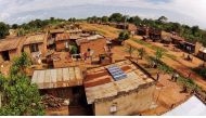 A photo taken from above by a drone shows solar panels on a rooftop in a Ugandan village. /SunFunder/Solar Now