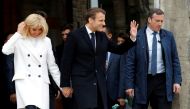 FILE PHOTO: French President Emmanuel Macron and his wife Brigitte leave after casting their ballots during the European Parliament Elections, in Le Touquet, France, May 26, 2019. REUTERS/Philippe Wojazer
