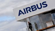FILE PHOTO: A man stands at an Airbus trade pavilion at Farnborough International Airshow in Farnborough, Britain, July 17, 2018. REUTERS/Toby Melville/File Photo