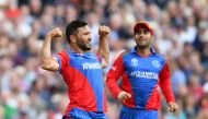 Afghanistan's captain Gulbadin Naib celebrates (L) taking the wicket of England's Jonny Bairstow for 90 runs during the 2019 Cricket World Cup group stage match between England and Afghanistan at Old Trafford in Manchester, northwest England, on June 18, 