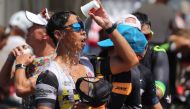 An athlete pours water on his face as he competes in an Ironman race in Frankfurt am Main, western Germany, where temperatures reached almost 39 degrees on June 30, 2019. AFP / Yann Schreiber 