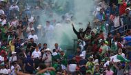 Spectators let off flares after the 2019 Cricket World Cup group stage match between Pakistan and Afghanistan at Headingley in Leeds, northern England, on June 29, 2019.  AFP / Lindsey Parnaby 