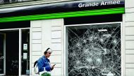 This picture taken on July 12, 2019, shows a broken window on the Grande Armee street, near the Arc de Triomphe in Paris where Algerian supporters celebrated the victory of their team during the 2019 Africa Cup of Nations (CAN) quarter final football matc