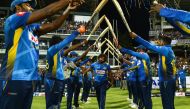 Sri Lankan cricketer Lasith Malinga (C) receives a farewell from his teammates after declaring his retirement from One Day International (ODI) cricket at the start of the first One Day International (ODI) cricket match between Sri Lanka and Bangladesh at 