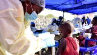FILE PHOTO: A Congolese health worker administers ebola vaccine to a child at the Himbi Health Centre in Goma, Democratic Republic of Congo, July 17, 2019. REUTERS/Olivia Acland