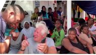 U.S. actor Richard Gere talks to a rescued migrant aboard Open Arms rescue boat at Mediterranean sea, in this screen grab taken from a video, August 9, 2019. (Open Arms/Reuters TV via REUTERS)
