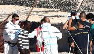 A minor who was among migrants stranded on the Spanish migrant rescue ship Open Arms disembarks in Lampedusa, Italy August 17, 2019. (REUTERS/Guglielmo Mangiapane)
