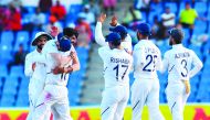 Ishant Sharma (L) and Virat Kohli (2L) of India celebrates the dismissal of Kemar Roach of West Indies during day 2 of the 1st Test between West Indies and India at Vivian Richards Cricket Stadium in North Sound, Antigua and Barbuda, on August 23, 2019. A