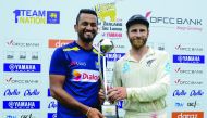 Sri Lanka's cricket team captain Dimuth Karunaratne (L) and New Zealand's cricket team captain Kane Williamson hold the trophy during the presentation ceremony on the final day of the final cricket Test match between Sri Lanka and New Zealand at P. Sara O