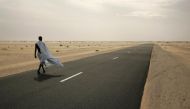 A man walks on the road between Nouahibou and Nouakchott, Mauritania in a December 3, 2009 file photo. (Reuters / Rafael Marchante) 