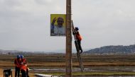 Municipal workers hang the portrait of Pope Francis ahead of his visit to Madagascar, in Antananarivo, Madagascar, September 4, 2019. Reuters/Baz Ratner