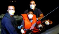 A Tunisian migrant is assisted by Armed Forces of Malta sailors during his medical evacuation to Malta from the German NGO Sea-Eye migrant rescue ship 'Alan Kurdi' in international waters off Malta in the central Mediterranean Sea, September 9, 2019. Reut