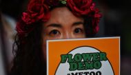 This file photo taken on June 11, 2019 shows a demonstrator holding a placard during a protest against the lack of substantial legal protection for sexual assault victims in Tokyo. AFP / Charly Triballeau
