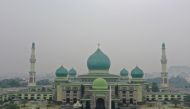A mosque is seen as smoke and haze choke the air over Pekanbaru on September 15, 2019.  AFP / Adek Berry 