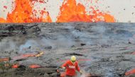 A geologist is collecting sample of molten lava from 2011 Kamoamoa eruption at Kilauea Volcano Hawaii ,US,  (USGS handout via Reuters)