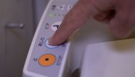 A person presses a button on the control panel of a Japanese toilet, in Tokyo, Japan September 24, 2019. REUTERS/Lucien Libert 