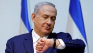Israeli Prime Minister Benjamin Netanyahu looks at his watch before delivering a statement at the Knesset, Israel's parliament, in Jerusalem December 19, 2018. Reuters/Amir Cohen