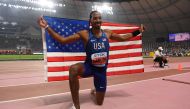 USA's Christian Taylor celebrates with the national flag after winning the Men's Triple Jump final at the 2019 IAAF World Athletics Championships at the Khalifa International Stadium in Doha on September 29, 2019. (AFP / Kirill KUDRYAVTSEV)
