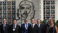 Russia's Prime Minister Dmitry Medvedev stands near an image of late revolutionary hero Ernesto 