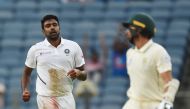 India's bowler Ravichandran Ashwin (L) celebrates after taking the wicket of South Africa's batsman Keshav Maharaj (R) during the third day play of second test cricket match between India and South Africa, at the Maharashtra Cricket Association Stadium in