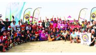 Riders and officials pose for a group photo after the opening round of MTB racing season held in Al Khor. 